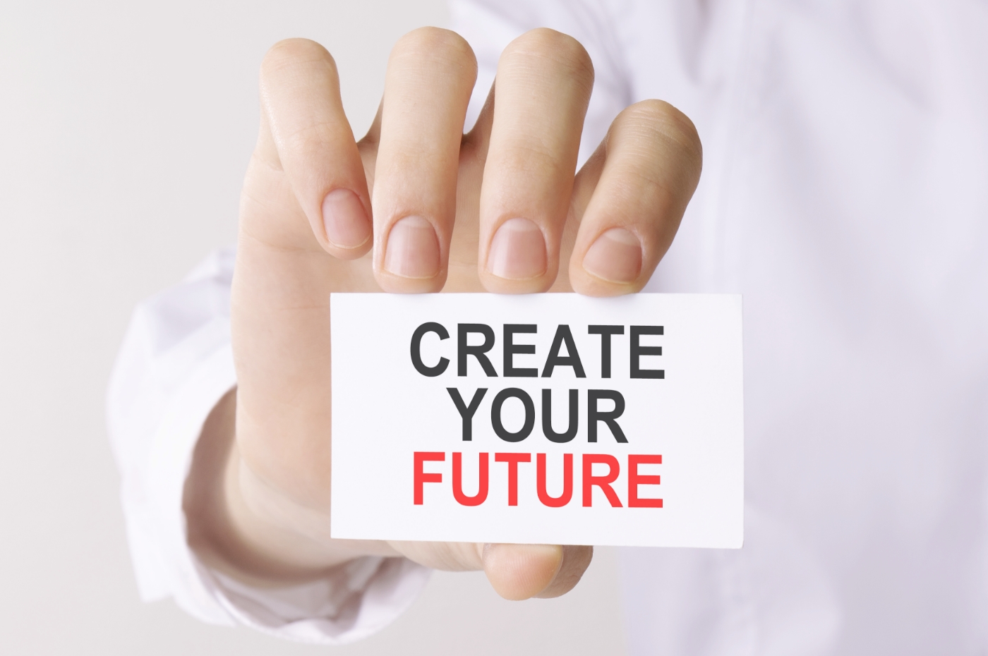 man-holding-card-with-text-create-your-future